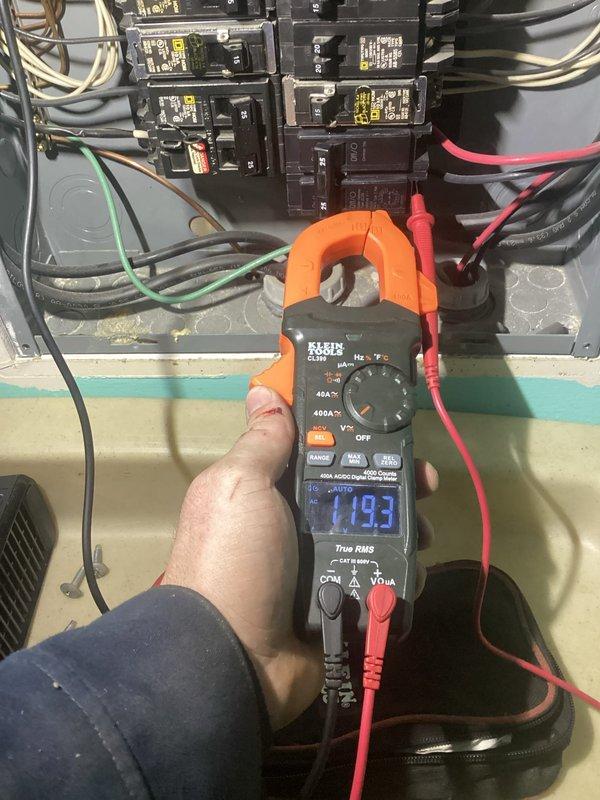Responded to no cooling call with fan not operating. Upon arrival, performed electrical diagnostics at the breaker panel using digital clamp meter to measure voltage and amperage. Readings indicated abnormal electrical values at the main panel, with measurements showing 1183 and 2294 on the meter display during testing. Inspected circuit breakers, wiring connections, and power supply to the AC unit. Identified electrical supply issue affecting unit operation. Documented findings with photos of electrical measurements at the panel for reference and further evaluation of power delivery to the system.