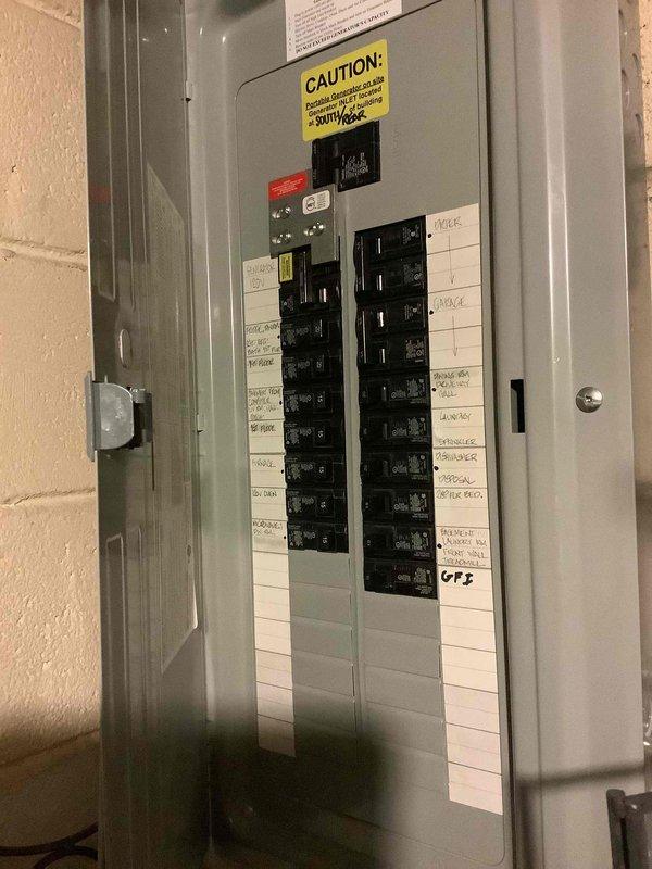 Conducted on-site evaluation for whole-house Generac generator installation at approximately 60-year-old residential property. Assessed existing electrical service panel configuration and capacity to determine appropriate generator sizing and transfer switch requirements. Documented current 120/240V split-phase electrical panel with standard circuit breaker arrangement. Evaluated mechanical room layout and available space adjacent to water heater and utility equipment for potential generator placement and fuel line routing. Photographed electrical panel labeling and circuit organization to calculate essential load requirements for automatic transfer switch specification. Inspection revealed adequate access for exterior generator pad installation and utility connections. Assessment complete for generator system proposal including unit sizing, transfer switch selection, and installation scope.