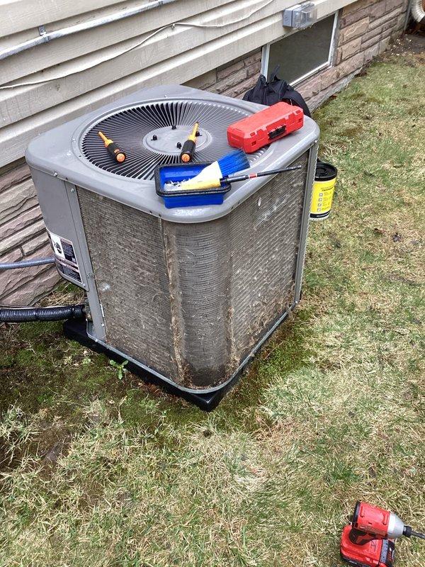 Completed comprehensive spring maintenance inspection on residential HVAC system under ComfortGuard Maintenance Package contract. Performed AC tune-up on 3-year-old central air conditioning system and inspected furnace unit. Accessed furnace cabinet to inspect blower motor assembly, control boards, electrical connections, and wiring harnesses; verified all LED indicators functioning properly and confirmed secure wire connections throughout internal compartment. Proceeded to outdoor condenser unit to complete cooling system maintenance, including inspection of compressor, condenser coil, fan assembly, and refrigerant service ports. Cleaned condenser coils, verified proper airflow through mesh grille, and tested fan motor operation. Checked refrigerant levels and system pressures at brass service ports. Confirmed both heating and cooling systems operating within manufacturer specifications with no deficiencies noted. All components functioning properly upon completion of scheduled mainte