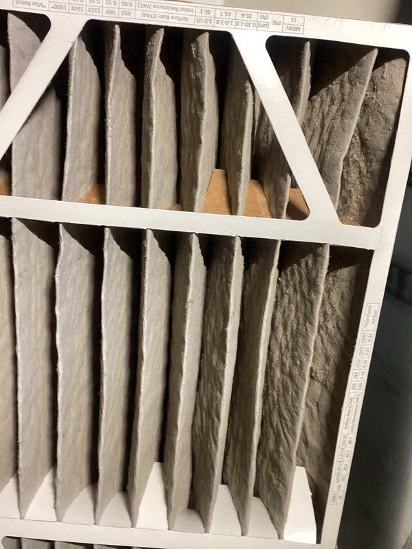 Completed comprehensive HVAC maintenance service including air filter replacement and zone system evaluation. Replaced heavily soiled pleated air filter that showed significant dust accumulation and uneven debris distribution throughout the media. Performed temperature diagnostics using precision instrumentation, recording ambient temperature of 71.5°F and verifying thermostat operation at 73°F setpoint in cooling mode. Assessed zone control system performance in response to reported temperature inconsistencies across multiple rooms, confirming system operation and thermostat communication.