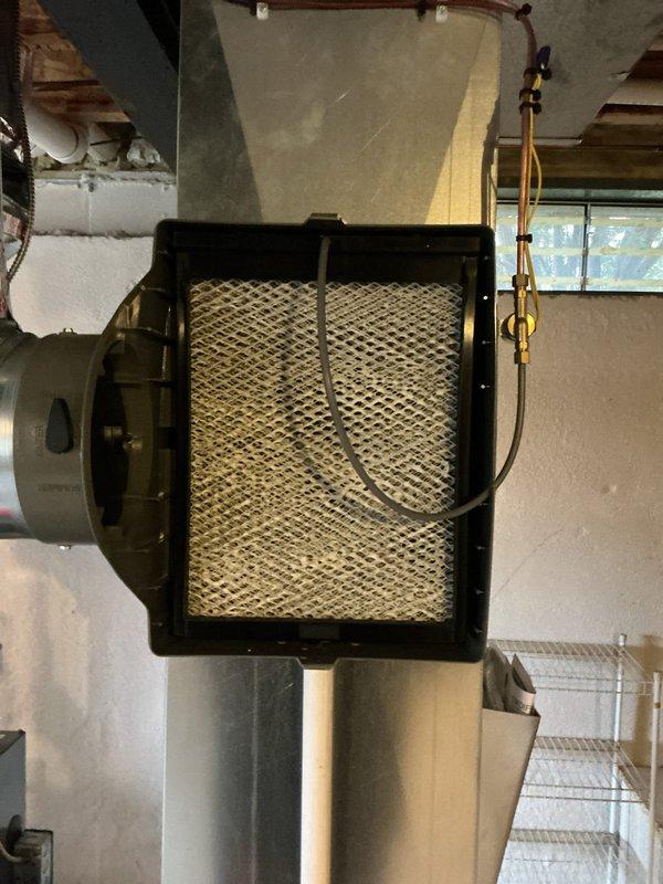 Completed routine HVAC maintenance on a one-year-old central air conditioning and furnace system. Performed comprehensive AC tune-up including inspection of air handler unit, verification of proper airflow through pleated air filter, examination of refrigerant lines and mounting brackets, and assessment of blower motor assembly. Confirmed digital thermostat operation and system functionality, with heating set to 68°F. All components operating within normal parameters with no deficiencies noted at time of service.