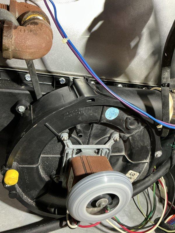 Completed annual heating maintenance inspection on residential furnace system. Addressed recall item and repaired broken spade connector for AC unit that was damaged during previous service visit. Discussed combustion analysis service with homeowner, explaining the diagnostic procedure and its benefits for system efficiency and safety monitoring. Inspected blower motor assembly, fan wheel, and associated electrical connections, all components found in satisfactory operating condition with normal wear patterns. Documented internal mechanical components including motor housing, wiring harness, and copper refrigerant lines showing typical surface oxidation. Replaced air filter as part of routine maintenance protocol.