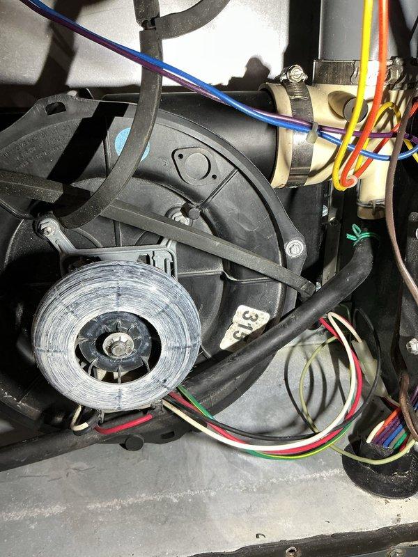Completed annual heating maintenance inspection on residential furnace system. Addressed recall item and repaired broken spade connector for AC unit that was damaged during previous service visit. Discussed combustion analysis service with homeowner, explaining the diagnostic procedure and its benefits for system efficiency and safety monitoring. Inspected blower motor assembly, fan wheel, and associated electrical connections, all components found in satisfactory operating condition with normal wear patterns. Documented internal mechanical components including motor housing, wiring harness, and copper refrigerant lines showing typical surface oxidation. Replaced air filter as part of routine maintenance protocol.