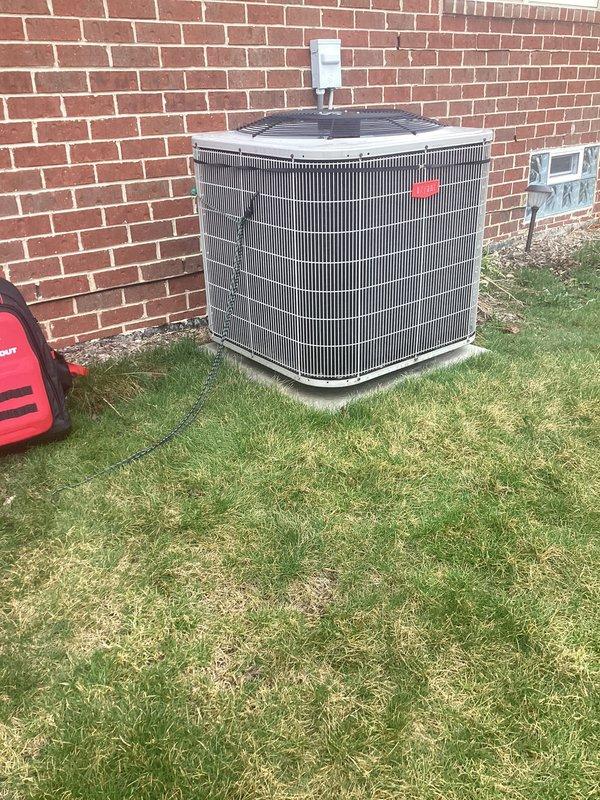 # Summary

Completed routine air conditioner maintenance on a 14-year-old central AC system for a maintenance plan member, with all components operating within normal parameters.

# Work Performed

Performed comprehensive preventive maintenance on outdoor condensing unit positioned on exterior brick wall. Conducted visual inspection of condenser cabinet, housing, and protective grille, confirming structural integrity and proper clearances. Verified electrical disconnect box mounting and functionality.

Connected Fieldpiece digital manifold gauge set to service ports to evaluate system performance. Recorded refrigerant pressures and temperatures on both high and low sides of the system. Analyzed superheat and subcooling values to assess proper refrigerant charge levels. All readings indicated system is operating within manufacturer specifications.

Inspected condenser coil fins for debris, damage, and airflow restrictions. Examined fan motor operation, blade condition, and bearing integ