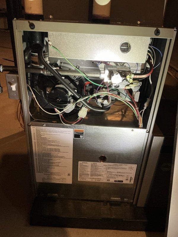 Completed comprehensive 5-year ComfortGuard maintenance inspection on residential furnace system. Performed thorough examination of internal components including blower motor assembly, electrical connections, wire harnesses, capacitor, and control circuitry. Verified all wiring connections were secure and properly terminated. Inspected manufacturer labels and unit specifications for compliance. Documented equipment condition with photos showing access panel removal and component inspection. All systems operating within normal parameters with no deficiencies noted.