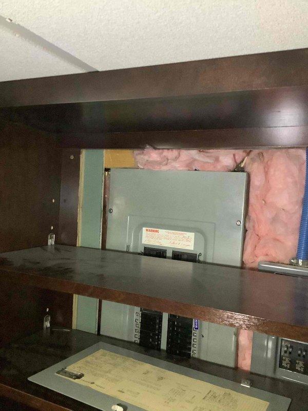 Conducted site assessment and provided quote for Kohler standby generator installation at 45-year-old residential property. Evaluated existing electrical service panel configuration housed within custom cabinetry, documented current electrical infrastructure including breaker panels and available space for generator transfer switch integration. Photographed electrical service equipment and potential generator placement area to determine installation requirements and verify compatibility with existing electrical system.