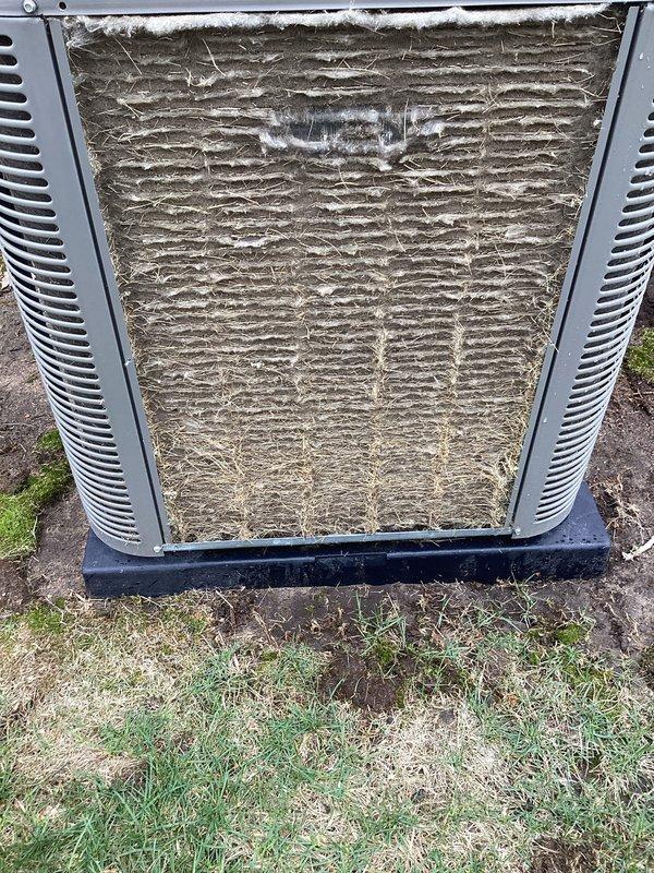 Performed routine Air Care Maintenance on outdoor condensing unit. Thoroughly cleaned heavily soiled condenser coil that exhibited significant accumulation of dirt, dust, and debris throughout the fin surfaces. Inspected unit housing, louvers, and base pan, confirming structural integrity and proper positioning on pad.
