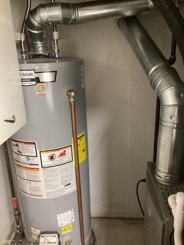 Completed installation of chimney liner system for residential water heater venting application. Installed rigid metallic ductwork with proper elbows and joints, secured all components with appropriate mounting straps and brackets, and connected flexible duct sections to complete the venting pathway from the A.O. Smith ProLine water heater through the mechanical space. All connections were properly sealed, system was verified for structural integrity, and installation meets code requirements for safe exhaust venting.