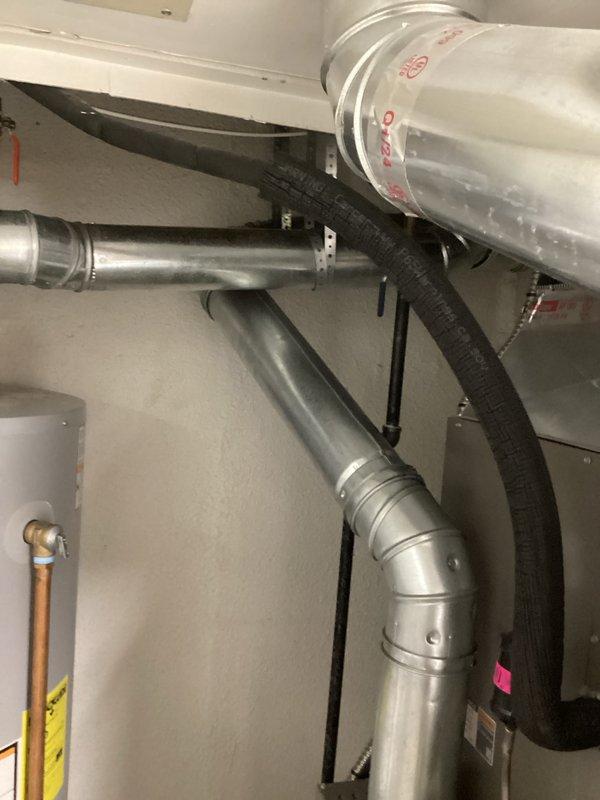Completed installation of chimney liner system for residential water heater venting application. Installed rigid metallic ductwork with proper elbows and joints, secured all components with appropriate mounting straps and brackets, and connected flexible duct sections to complete the venting pathway from the A.O. Smith ProLine water heater through the mechanical space. All connections were properly sealed, system was verified for structural integrity, and installation meets code requirements for safe exhaust venting.