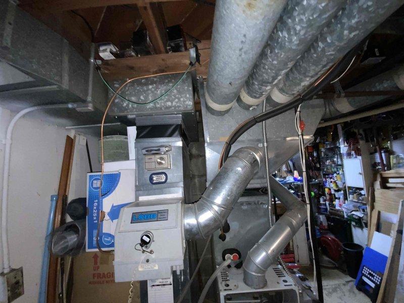 Provided comprehensive estimate for replacement of 24-year-old natural gas furnace and air conditioning system located in basement under buy-one-get-one promotional program. Current equipment remains operational but has reached end of expected service life. Assessment included evaluation of existing ductwork configuration, venting system, and spatial requirements for new installation in densely packed utility area with existing HVAC infrastructure and storage.