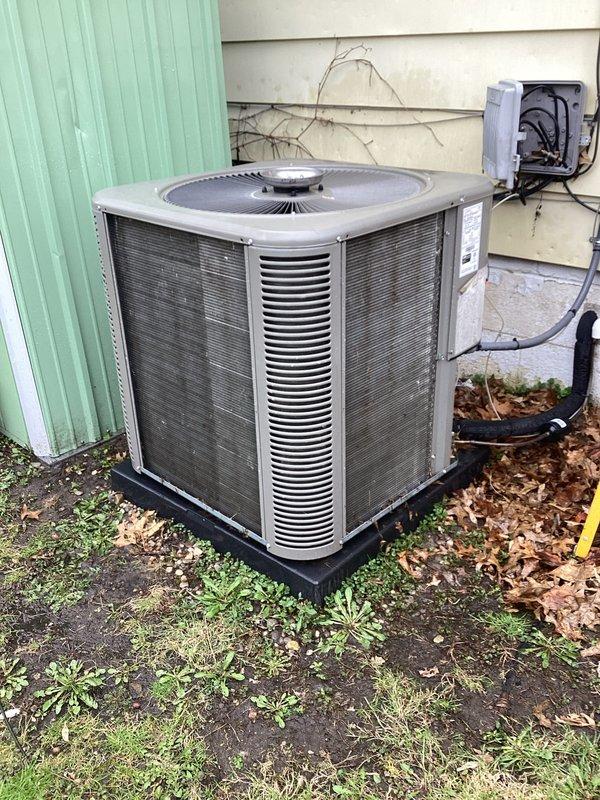 Completed annual maintenance on a 3-year-old residential central air conditioning system as part of year-end warranty compliance. Performed comprehensive AC tune-up including inspection of condenser unit, which showed significant accumulation of dirt, dust, and organic debris on condenser fins and coils. Cleaned condenser coils to restore proper airflow and heat transfer efficiency, removed leaves and vegetation debris from unit exterior and surrounding base area. Inspected refrigerant lines, electrical connections, and disconnect box for proper operation. Verified system operational parameters and confirmed all components functioning within manufacturer specifications with no issues identified.