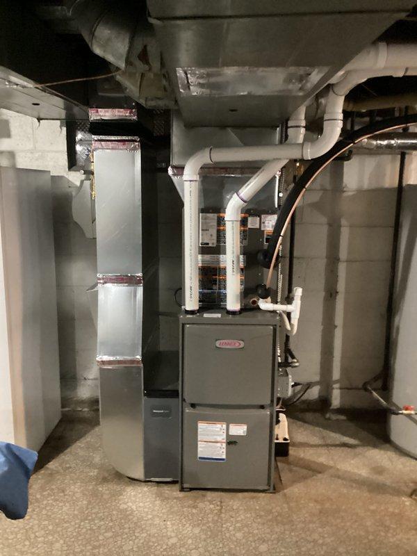 Completed full HVAC system installation including a 70,000 BTU Lennox furnace with humidifier and 2-ton air conditioning unit with rear discharge configuration. Installed and routed all necessary ductwork, refrigerant lines, and electrical connections in basement mechanical room. Reconnected existing components and obtained mechanical and electrical permits for the complete system replacement.