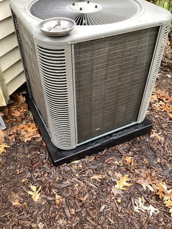 Completed annual comprehensive maintenance on residential HVAC system. Inspected outdoor condenser unit, noting significant debris accumulation on coil fins and surrounding area with leaves and dirt buildup from seasonal exposure. Replaced furnace filter as scheduled. Documented equipment condition through photos showing condenser coil surface with weathering, dust accumulation, and white streaking on fins, as well as overall unit exterior showing signs of normal outdoor wear. Unit operational at time of service completion.