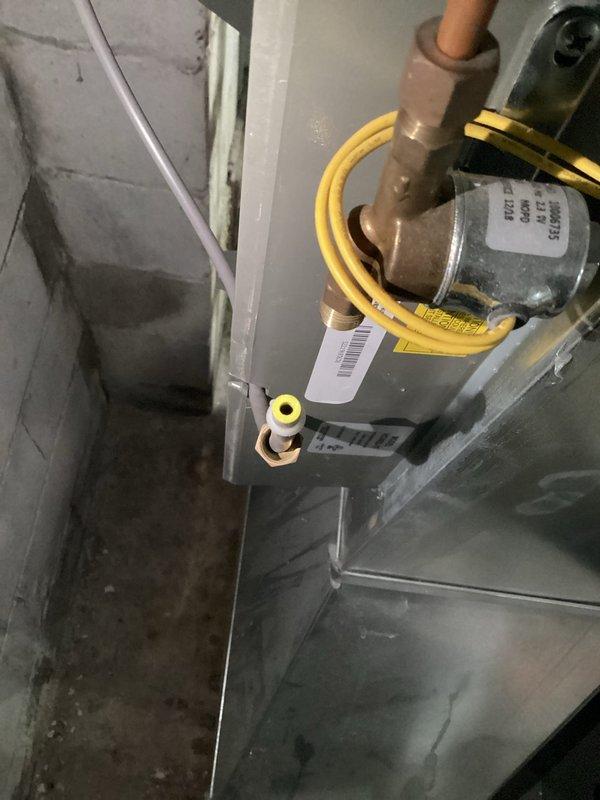 Responded to service call for leaking furnace-mounted humidifier on six-year-old HVAC system. Upon arrival, confirmed heating system was operating normally with no impact to primary function. Inspected humidifier unit and associated water supply lines, identifying source of leak at water feed connection. Documented equipment condition through photographs showing humidifier cabinet, internal components including distribution pad and water panel, and surrounding ductwork connections. Verified proper operation of blower motor and air handler components. Addressed leak issue and confirmed system integrity. Unit returned to normal operation with no further water discharge observed.