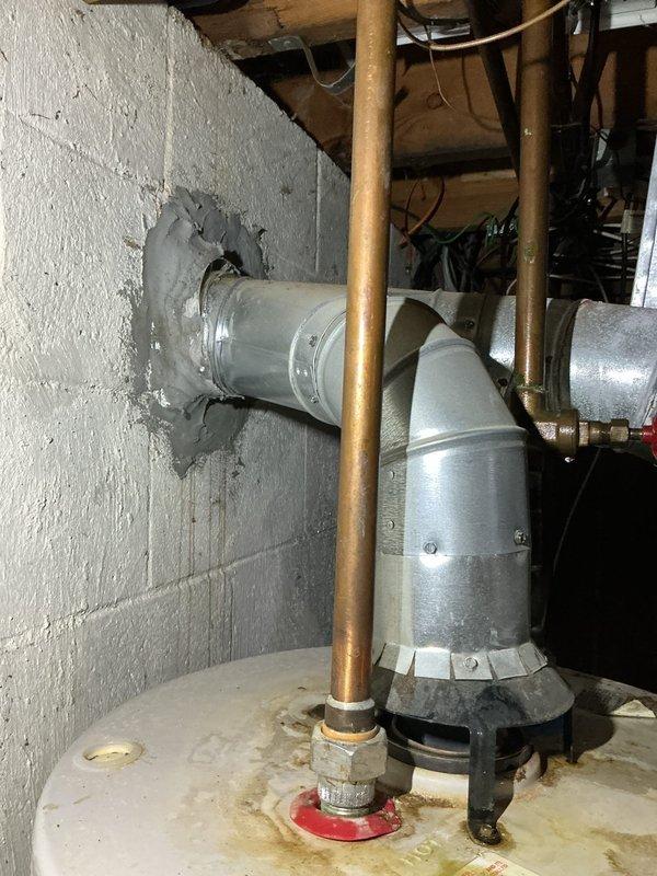 Responded to service call for humidifier leaking water. Upon inspection, found water staining on floor beneath humidifier installation connected to existing HVAC ductwork system. Assessed humidifier unit, associated plumbing connections, and water supply line for source of leak. Documented existing conditions with photographs showing copper piping, ductwork configuration, and evidence of water damage on concrete floor surface beneath unit.