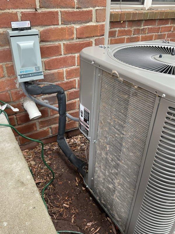 Completed comprehensive ComfortGuard preventive maintenance service on residential split-system air conditioning unit. Performed full system inspection of outdoor condenser unit, verified proper operation of compressor and condenser fan motor, cleaned condenser coils, checked refrigerant line insulation integrity, and confirmed electrical disconnect box functionality. All components found operating within normal parameters with no deficiencies noted.