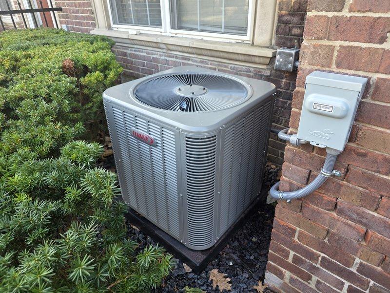 Responded to callback for violation repair on recently installed Lennox 70,000 BTU furnace and 2-ton AC system. Inspector cited NEC 440.14 and 110.26(A)(1)(2)(3) violation for insufficient clearance at AC condenser service disconnect, requiring 36 inches from grounded and ungrounded surfaces. Relocated electrical disconnect box on exterior brick wall to achieve proper clearance specifications and ensure code compliance. Installed whole home surge protector as additional scope item. Verified all electrical connections, tested system operation, and confirmed unit functionality with proper airflow through condenser louvers. Installation now meets all NEC requirements with disconnect accessible and properly positioned relative to condensing unit mounted on pad.