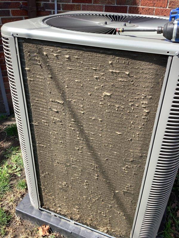 # HVAC Maintenance - ACM Completed

Performed routine air conditioning maintenance on outdoor condensing unit. Upon arrival, found the condenser coil heavily soiled with accumulated dirt, dust, and debris buildup affecting airflow and system efficiency. Thoroughly cleaned and washed condenser coil to restore proper heat transfer capability. Replaced dirty air filter with new filter, as evidenced by comparison of heavily soiled original filter against fresh replacement. Inspected unit pad and verified stable positioning on concrete base. System operational following maintenance completion.