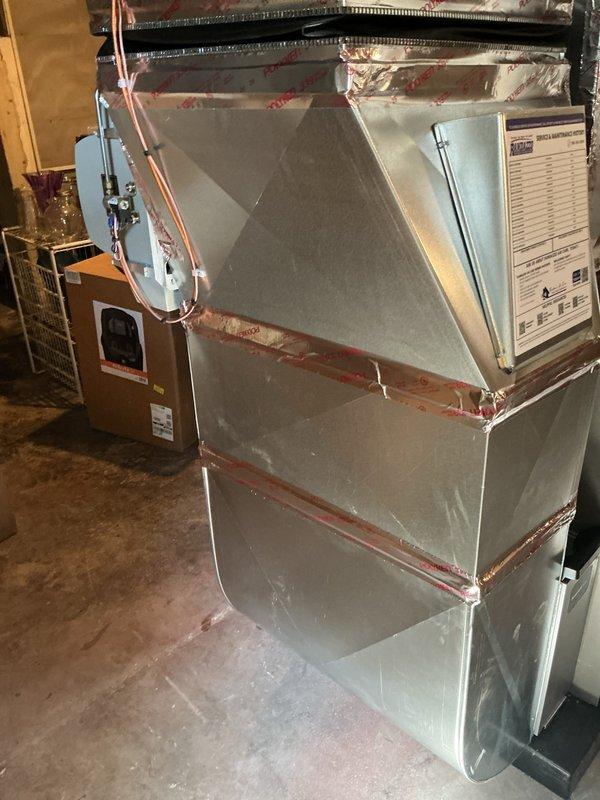Completed callback inspection on recently installed 90,000 BTU furnace and air handler system with air conditioning unit. Verified proper installation of all components including refrigerant line connections, PVC condensate drainage, electrical connections at control panel, and ductwork transitions. Confirmed furnace mounted securely on base platform with appropriate clearances, air handler properly positioned with all access panels secured, and filtration system accessible for maintenance. All mechanical and electrical permits obtained and system operating within manufacturer specifications.