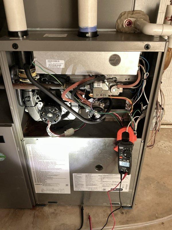 Completed routine ACM maintenance on residential cooling system, including replacement of air filter and evaporative cooler pad as scheduled. Performed diagnostic measurements on both indoor furnace unit and outdoor condensing unit, verifying electrical current draw of 0.063 amps at contactor and confirming gas valve assembly operation with multimeter reading of 133 millivolts at flame sensor circuit. All components operating within normal parameters, system left in proper working condition.