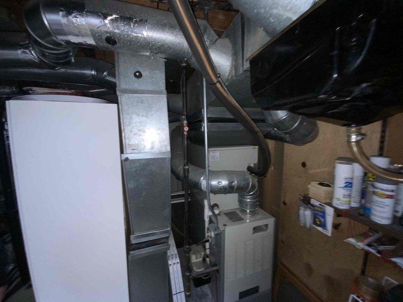 Provided estimate for replacement of 20+ year old furnace and air conditioning system located in basement mechanical room. Current equipment operational but at end of service life. Quote includes furnace and air handler replacement with associated ductwork modifications as needed for proper installation in existing utility space shared with water heater and other mechanical systems.