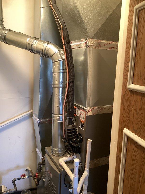 Completed full HVAC system installation including a 45,000 BTU furnace and 1.5 ton air conditioning unit. Removed existing aged outdoor condenser unit and installed new replacement unit on concrete pad with proper refrigerant line connections and electrical hookup. Installed new furnace in basement utility area with complete ductwork integration, including flexible and rigid metallic ducting for optimal airflow distribution. Ran copper refrigerant lines with insulation sleeves from outdoor condenser to indoor air handler, securing lines to exterior brick wall with protective conduit boxes. Installed PVC condensate drain piping and venting systems per code requirements. Reconnected all ductwork to existing distribution system and verified proper sealing at all connections. System startup performed with verification of proper refrigerant charge, airflow measurements, and thermostat operation. All mechanical permits obtained and installation completed to manufacturer specifications and lo