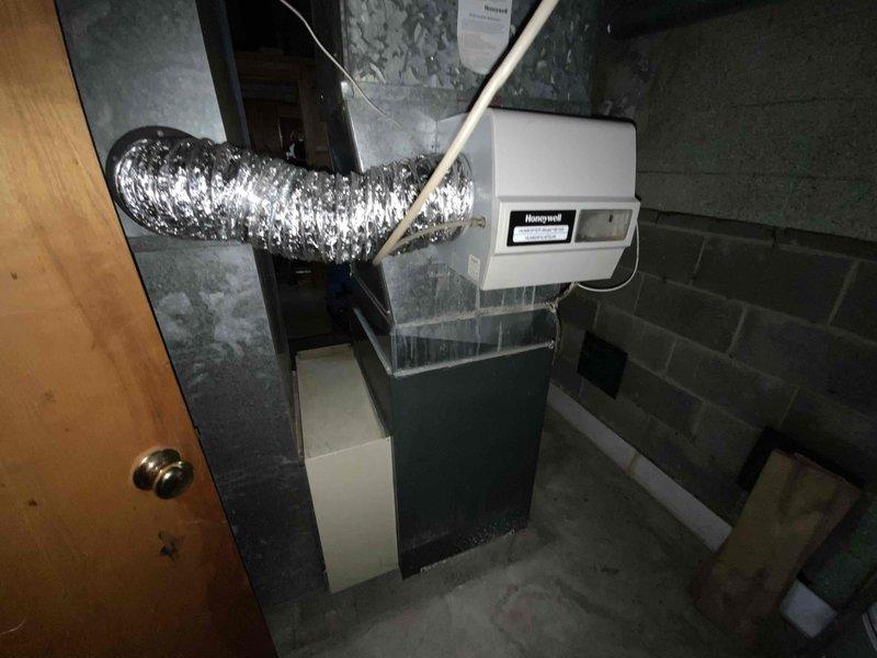 Provided estimate for replacement of non-functional outdoor air conditioning unit located at exterior corner of brick building. Existing AC condenser is inoperable and requires full replacement, while the 5-year-old furnace will remain in service. Assessment included evaluation of current refrigerant line set, electrical disconnect, and indoor air handler compatibility for new system installation.