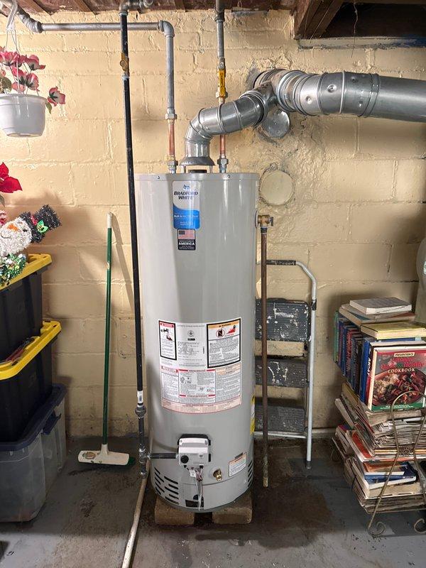 Successfully installed a 40-gallon tanked water heater in basement utility area. Removed existing unit and installed new water heater with proper copper supply line connections, including hot and cold water piping with shutoff valves and dielectric unions. Connected temperature and pressure relief valve with discharge piping to code specifications. Installed flue vent piping for proper exhaust ventilation. All connections pressure tested and verified leak-free. Unit fired up and tested for proper operation, with temperature settings adjusted per manufacturer specifications. Permits were obtained prior to installation to ensure compliance with local mechanical codes. System fully operational upon completion with all safety features verified functional.