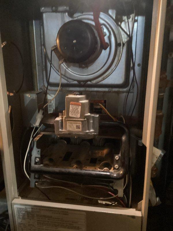Completed comprehensive Air Care Heating and Cooling maintenance service on residential HVAC system. Performed thorough inspection of outdoor condensing unit, documenting significant filter contamination and debris accumulation restricting airflow, and examined internal components including blower motor assembly, gas valve, burner assembly, and refrigerant lines to ensure proper system operation.