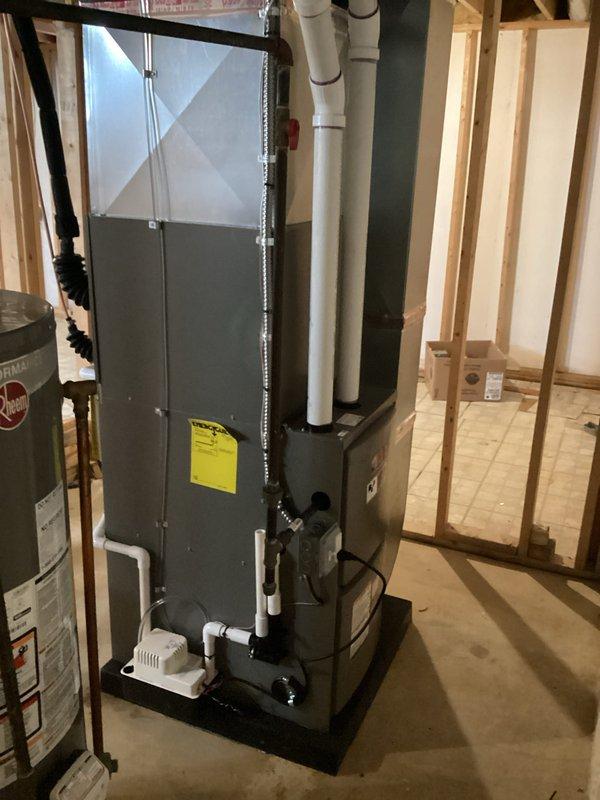 Completed full HVAC system installation including a 70,000 BTU furnace and 2-ton air conditioning unit with rear placement configuration. Obtained mechanical and electrical permits prior to installation, installed air handler unit on raised platform in basement utility area with proper PVC condensate drainage and ventilation piping, completed all electrical connections to existing panel box, and reconnected all necessary components to ensure full system operation.