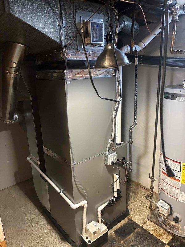 Completed full HVAC system installation including a 90,000 BTU furnace and 3-ton rear-discharge air conditioning unit in basement mechanical room. Installation included humidifier integration, duct liner application, and reconnection of all existing utilities and ductwork. Obtained mechanical and electrical permits prior to installation, ensuring all work meets code requirements and manufacturer specifications for optimal system performance and efficiency.