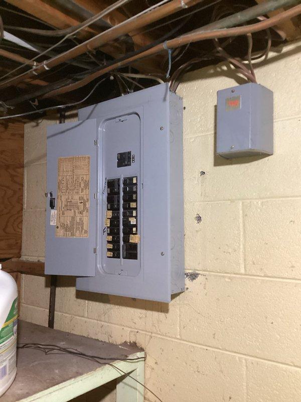 Completed comprehensive whole home electrical inspection on 1964-built residence with no specific concerns reported. Performed thorough evaluation of main electrical panel located in basement utility area, documenting breaker configuration, circuit directory, and overall panel condition. Inspected all visible electrical components including junction boxes, conduit runs, and wiring throughout accessible areas. Assessed electrical infrastructure in mechanical room including connections to water heater and associated utility equipment. Documented all findings with photographs for customer records.