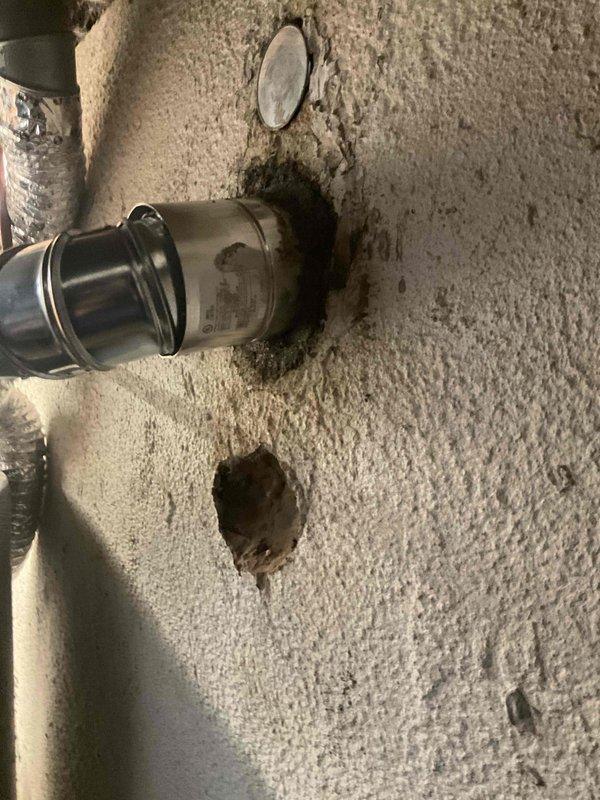 Completed chimney liner installation for water heater venting system. Dropped and secured stainless steel flexible liner through existing ceiling penetration, connected to water heater flue outlet with proper metal elbow fitting and securing bands. Verified proper draft and clearances per manufacturer specifications.