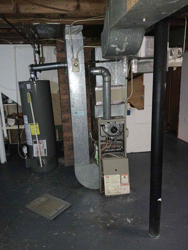 Provided estimate for replacement of non-operational gas furnace located in basement mechanical room. Existing unit is very old and no longer functioning, requiring complete system replacement. Assessment included evaluation of current ductwork, venting requirements, and available space for new equipment installation in unfinished basement area with exposed joists.