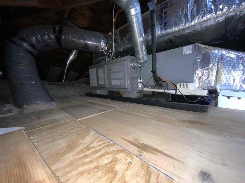 Completed full system HVAC estimate for 23-year-old non-operational residential heating and cooling system located in attic space. Assessed existing air handler unit, ductwork configuration, and overall system layout including flexible metallic ductwork distribution throughout the space. Documented current equipment condition, drain pan placement, and structural considerations for complete system replacement recommendation, with customer expressing interest in available financing options.