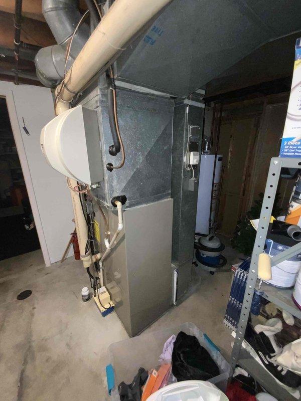 Conducted comprehensive full system estimate for 16-year-old HVAC system including furnace and air conditioning unit located in basement mechanical room. Performed thorough assessment of existing gray sheet metal furnace/air handler, associated ductwork, PVC condensate drainage lines, copper refrigerant tubing, and electrical connections. Documented current system configuration with detailed photography showing equipment condition, spatial constraints, and existing infrastructure including metal supply/return ductwork extending to ceiling distribution system. Provided replacement recommendations and equipment specifications for complete HVAC system upgrade to meet immediate replacement timeline within the month.