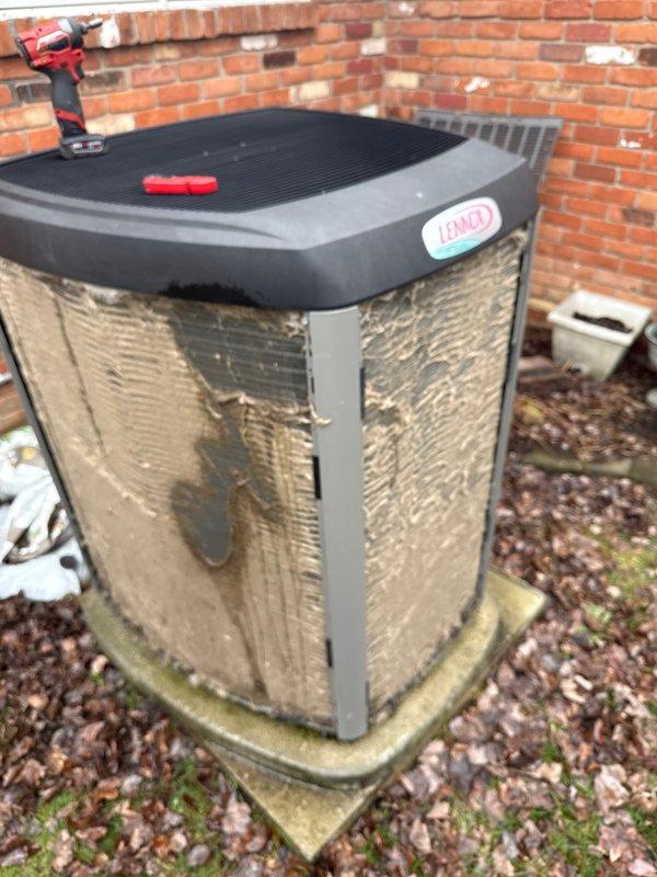 # HVAC Maintenance - ACM Completed

Performed scheduled preventive maintenance on residential Lennox air conditioning condensing unit. Conducted comprehensive inspection of outdoor equipment, checking all accessible components for proper operation and wear. Unit exterior showed significant weathering and age-related deterioration with visible discoloration and water staining on metal panels, though structural integrity remained intact.

Removed top grille to access internal components for cleaning and inspection. Verified condenser coil condition, checked refrigerant lines for leaks or damage, and inspected electrical connections for corrosion or loose terminals. Cleaned debris from unit surroundings and ensured adequate airflow clearance around equipment. All mechanical and electrical components found functioning within normal parameters. Unit operational and ready for continued service under ongoing maintenance agreement.