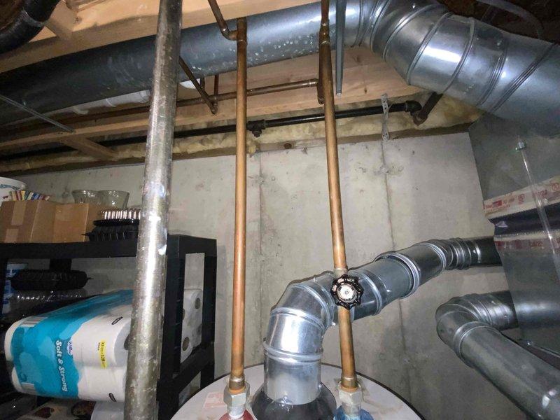 Conducted estimate for water heater replacement in basement location. Existing unit was non-operational and had reached end of serviceable life. Assessed installation area, existing copper supply piping with shut-off valves, venting configuration, and clearance requirements for new equipment installation.