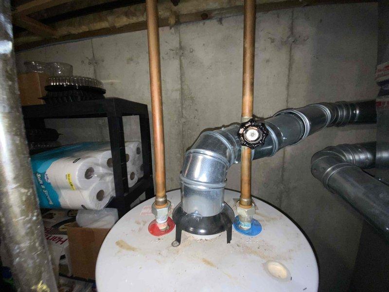 Conducted estimate for water heater replacement in basement location. Existing unit was non-operational and had reached end of serviceable life. Assessed installation area, existing copper supply piping with shut-off valves, venting configuration, and clearance requirements for new equipment installation.