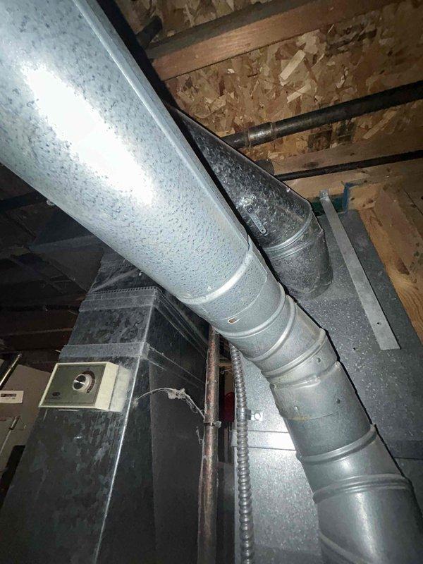 Provided comprehensive estimate for complete HVAC system replacement in basement installation, including furnace and air conditioning unit under BOGO promotion. Assessed existing 1991 equipment currently operational but at end of serviceable life, documented existing ductwork configuration including large main trunk line with insulated branches and flexible connections, and evaluated installation requirements for new high-efficiency system in existing basement mechanical space.