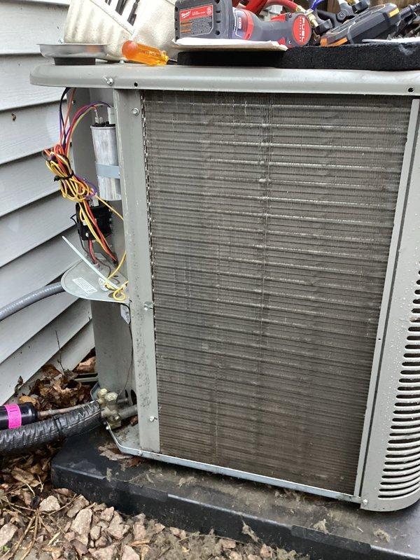 Completed scheduled Air Care Heating and Cooling maintenance on HVAC system. Performed comprehensive inspection of indoor furnace unit, verifying all electrical connections, wire terminations, and control components for proper operation. Inspected outdoor condensing unit, examining heat exchanger coil condition, capacitor connections, and overall system components. Documented equipment condition with photographs showing internal wiring configuration and outdoor unit accessibility for maintenance records.