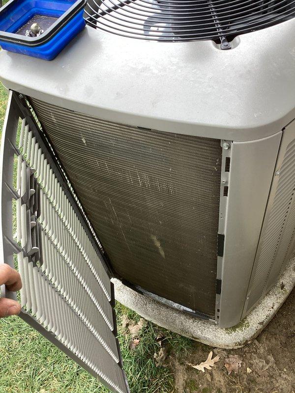 Performed routine air conditioning maintenance on residential condensing unit. Upon inspection, found condenser coil heavily soiled with accumulated dirt, dust, and lint buildup significantly restricting airflow. Cleaned condenser coil thoroughly to restore proper heat transfer efficiency and airflow through fins. Inspected all accessible components including fan motor, refrigerant lines, and electrical connections. Unit operational upon completion of maintenance service.
