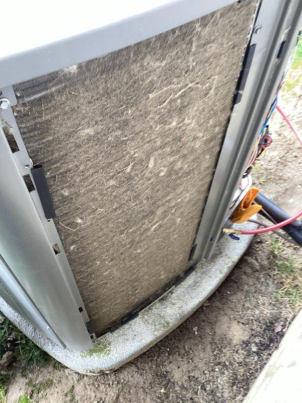 Performed routine air conditioning maintenance on residential condensing unit. Upon inspection, found condenser coil heavily soiled with accumulated dirt, dust, and lint buildup significantly restricting airflow. Cleaned condenser coil thoroughly to restore proper heat transfer efficiency and airflow through fins. Inspected all accessible components including fan motor, refrigerant lines, and electrical connections. Unit operational upon completion of maintenance service.