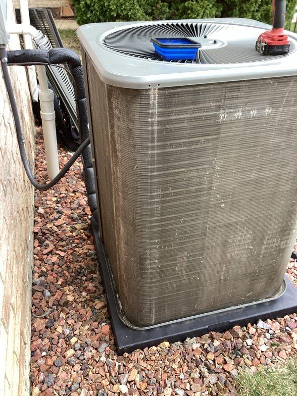 Completed comprehensive 5-year ComfortGuard maintenance inspection on residential outdoor air conditioning condenser unit. Performed thorough cleaning of condenser coils, fan assembly, and exterior cabinet panels to remove accumulated dirt, debris, and environmental buildup. Inspected and verified proper operation of all mechanical components including fan motor, compressor, and refrigerant line connections. Condenser unit showed normal weathering consistent with outdoor exposure; all systems functioning within manufacturer specifications upon completion of maintenance protocol.