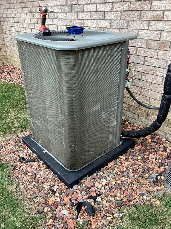Completed comprehensive 5-year ComfortGuard maintenance inspection on residential outdoor air conditioning condenser unit. Performed thorough cleaning of condenser coils, fan assembly, and exterior cabinet panels to remove accumulated dirt, debris, and environmental buildup. Inspected and verified proper operation of all mechanical components including fan motor, compressor, and refrigerant line connections. Condenser unit showed normal weathering consistent with outdoor exposure; all systems functioning within manufacturer specifications upon completion of maintenance protocol.