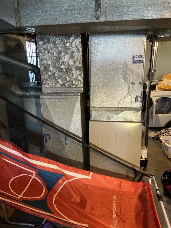 Conducted site assessment for furnace replacement in basement location. Evaluated existing 30+ year old natural gas furnace unit currently in non-operational condition, documented equipment configuration including ductwork connections, venting system, and clearance requirements for replacement installation.