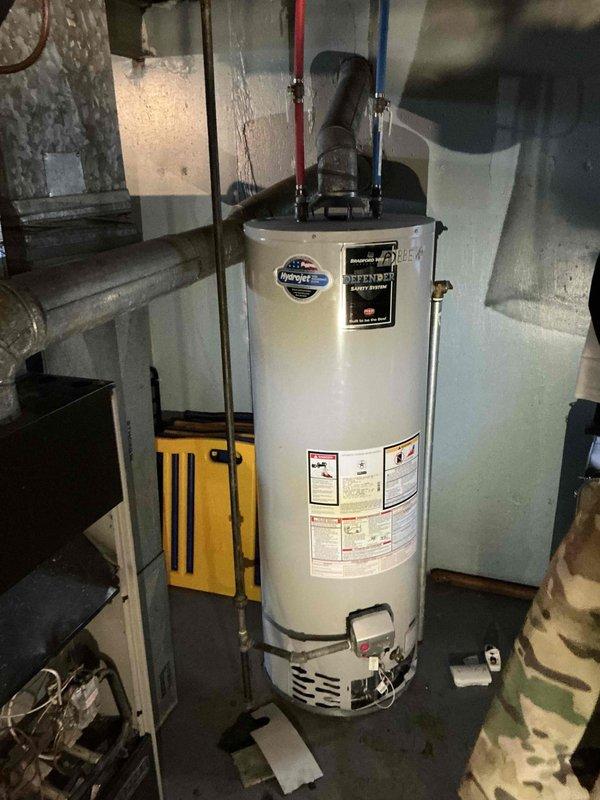 Conducted site assessment for furnace replacement in basement location. Evaluated existing 30+ year old natural gas furnace unit currently in non-operational condition, documented equipment configuration including ductwork connections, venting system, and clearance requirements for replacement installation.