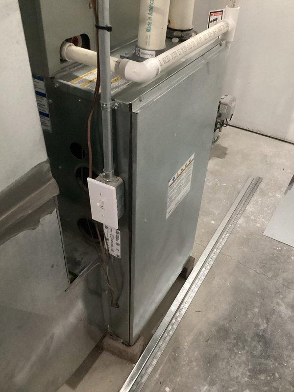 Completed annual furnace maintenance on residential HVAC air handler system installed in basement utility room. Performed comprehensive tune-up including inspection of all mechanical components, electrical connections, and associated PVC condensate drainage lines. Verified proper operation of furnace unit, examined ductwork connections, refrigerant lines, and manufacturer specifications. All systems tested and found operating within normal parameters. Documentation photos captured for service records.