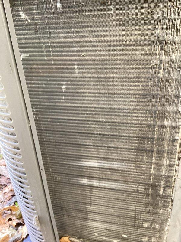 Completed annual cooling maintenance on outdoor condensing unit. Unit exterior and condenser coil showed heavy accumulation of dirt, dust, and debris from extended environmental exposure. Cleaned condenser coil fins thoroughly to restore proper airflow and heat transfer efficiency. Removed debris buildup from unit exterior panels and surrounding base area. Inspected fan assembly and verified operational condition. System restored to optimal performance standards following maintenance procedures.