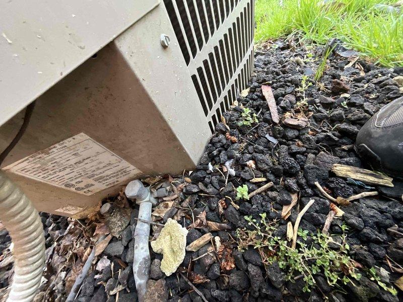 Conducted comprehensive assessment of non-operational HVAC system with equipment exceeding 10 years of service life. Evaluated basement-installed natural gas furnace with existing ductwork configuration and exterior air conditioning unit positioned on lava rock landscaping. Documented current system conditions including furnace cabinet, supply and return ductwork connections, and outdoor condensing unit placement to provide replacement equipment recommendations and installation specifications.